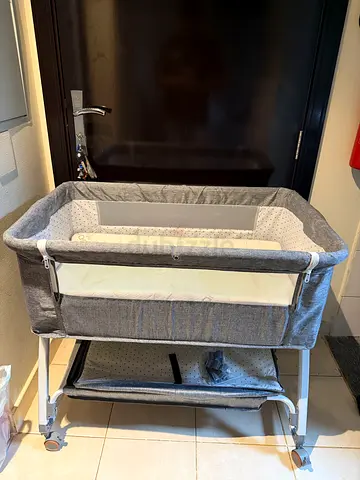 Light grey bedside bassinet / portable crib in good condition