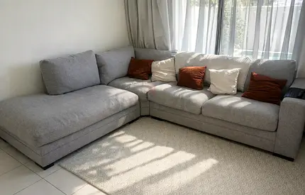 Home centre - grey L-shaped fabric corner sofa. Some staining the far left cushion but very clean