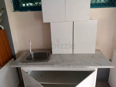 Use kitchen cabinet with sink and marble-look counter