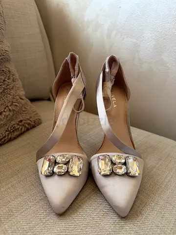 Beige satin pointed toe heels with crystal embellishments from brand CARVELA