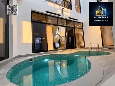 Own your luxurious two-story villa in Ajman with a rooftop terrace, an indoor pool, air conditionin