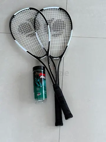Two squash rackets with canister of balls - good condition