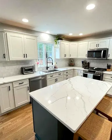 Modern white kitchen island with cabinets and quartz countertop