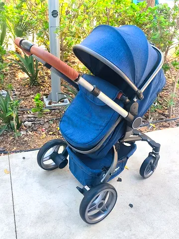 Blue full-size baby stroller with adjustable canopy and storage basket