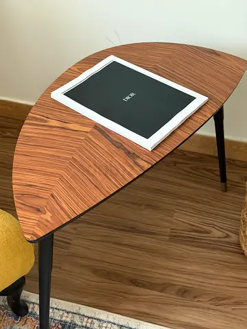 Half-moon wooden side table with black legs