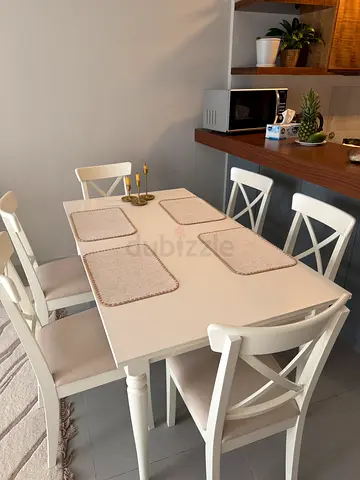 White wooden dining table with 6 chairs - good condition