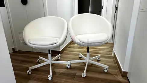 Pair of white swivel office chairs on wheels — good condition
