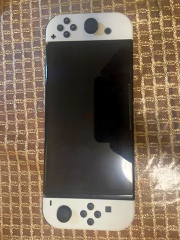 White Nintendo Switch OLED with dock, controller frame, (doesn’t include charger), 1 month used.