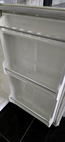 Small fridge freezer interior — spare replacement drawers and shelves