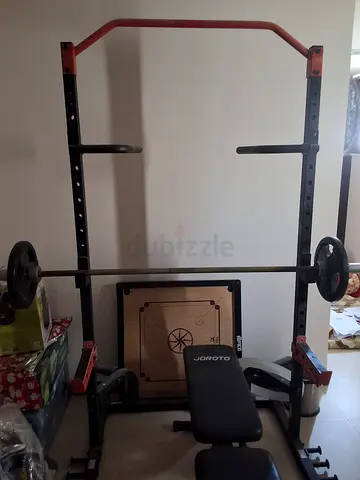 Gym power rack with barbell, bench and plates ( negotiable price)