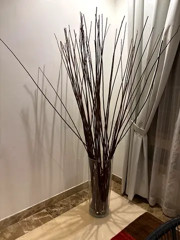 Tall decorative floor vase with long brown twig branches