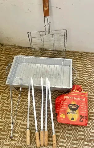 Portable charcoal BBQ grill with skewers and racks
