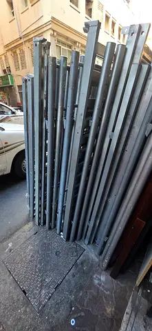 Used metal slotted upright posts for warehouse racking — lot of 12+