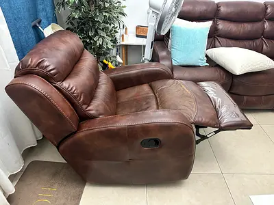 Brown leather recliner and rocker armchair  it is pretty comfortable and is in mint condition