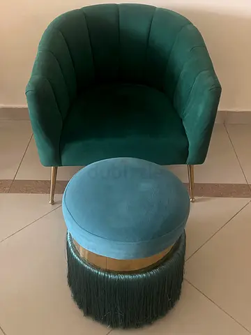 Green velvet tub chair with matching round ottoman
