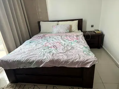 Queen wooden bed frame with storage and matching nightstand, including mattress.