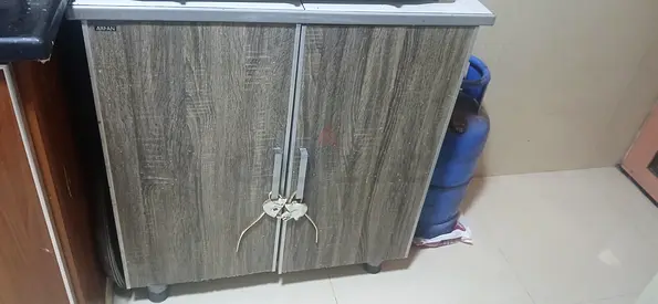 Small two-door kitchen cabinet / storage cupboard in wood finish