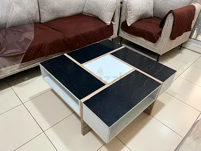 Modern square coffee table with black marble top and storage