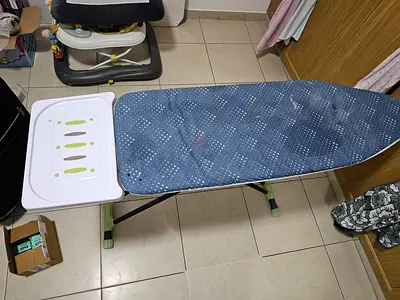 Adjustable ironing board with cover and iron rest - good condition