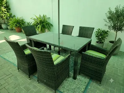 Elegant Outdoor Furniture Set Modern 7-piece outdoor dining set featuring a sleek glass tabletop and