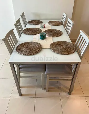 White glass top dining table with 6 chairs