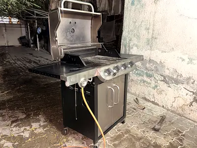 4-burner stainless steel gas BBQ grill with side shelves and cabinet