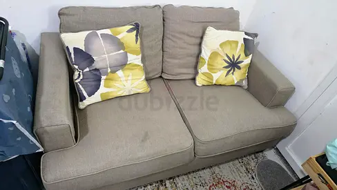2-seater beige fabric sofa in good condition