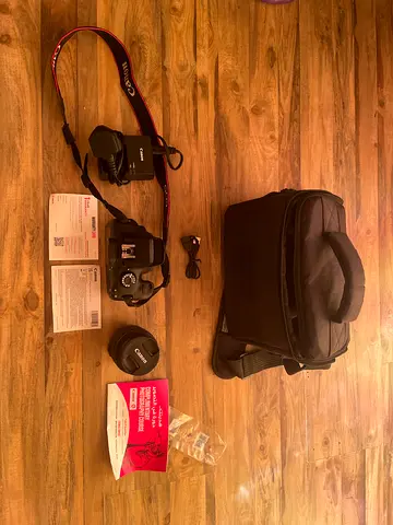 Canon DSLR (EOS 4000D) kit with bag, charger, lens cap and manuals - good condition
