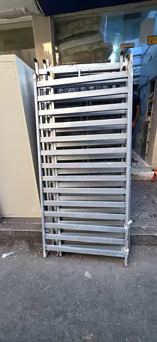 Used metal slotted upright posts for warehouse racking — lot of 12+