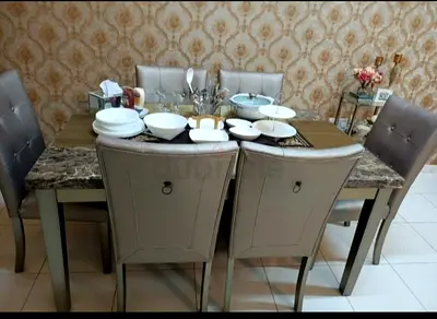 6-seater dining table set with padded chairs and marble-effect top