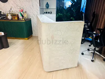 Used white plaster-style reception desk / counter - compact L-shape
