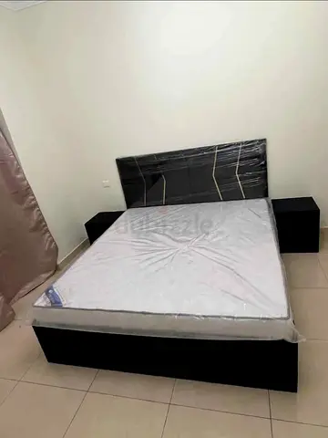 Queen size bed frame with mattress and two bedside tables - black