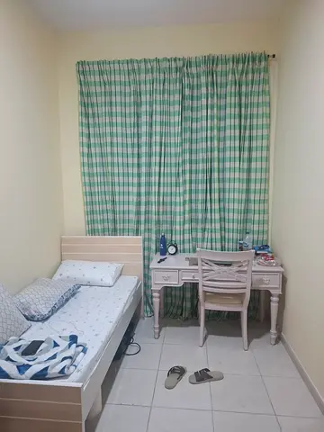 Bedspace available in a clean room with attached bathroom, suitable for a working professional