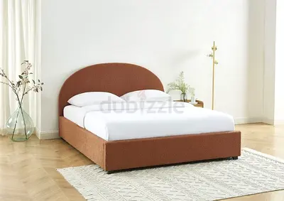 Brown upholstered double bed with rounded headboard