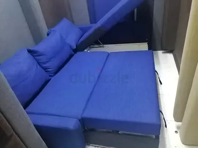 Blue fabric sofa bed — converts to comfortable double bed, good condition