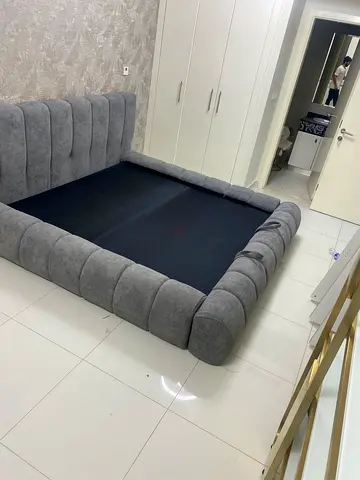 Grey upholstered bed frame - queen size (new)
