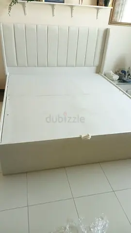 White upholstered double bed with storage,