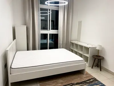 White wooden double bed frame with mattress
