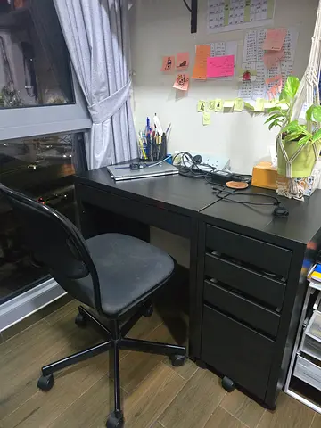 Black office desk with drawers and swivel chair — good condition