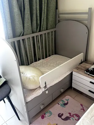 Grey convertible baby crib/mini cot with storage drawers — good condition