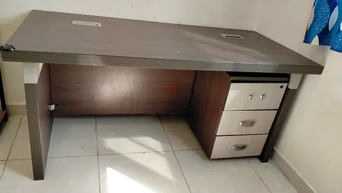 Used office desk with three-drawer pedestal, dark wood finish