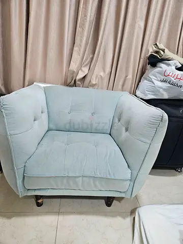 Light blue upholstered single armchair in good condition