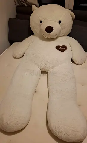 Giant white teddy bear with heart detail