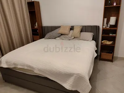 Grey upholstered SUPER KING bed with mattress, storage base and headboard. Flawless condition.