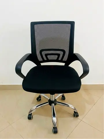 Black mesh ergonomic office chair with armrests and wheels