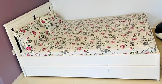 White wooden single bed with storage and mattress