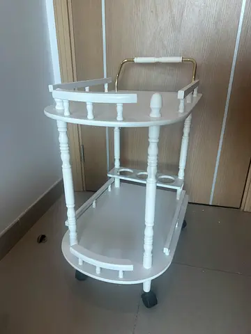 White wooden serving trolley on wheels — good condition