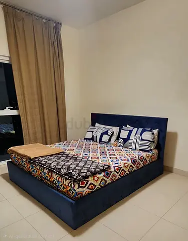 Blue upholstered King bed frame with headboard - and storage box under in good condition