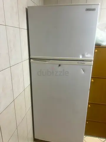 Two used white refrigerators/freezers - needs minor dents repair