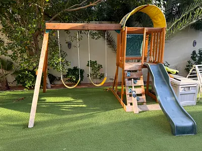 Wooden kids swing set with slide and climbing features - good condition